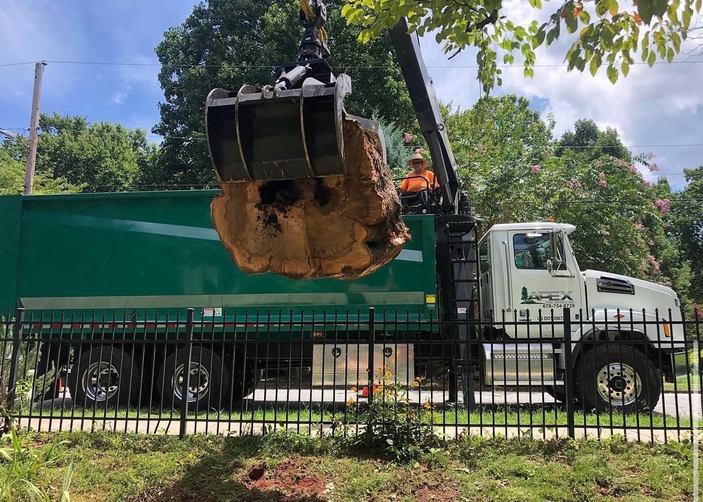 Apex grapple truck loading removed tree material